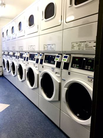 A row of washing machines in a laundromat.